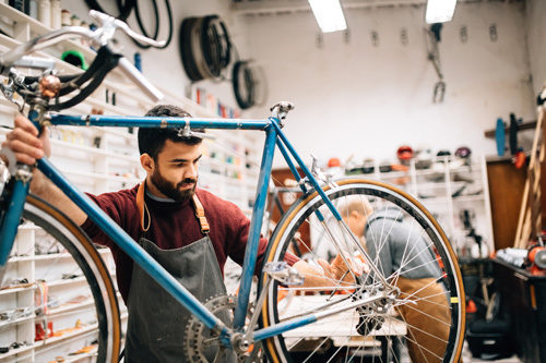 Man fixing bicycle in Bike Shop